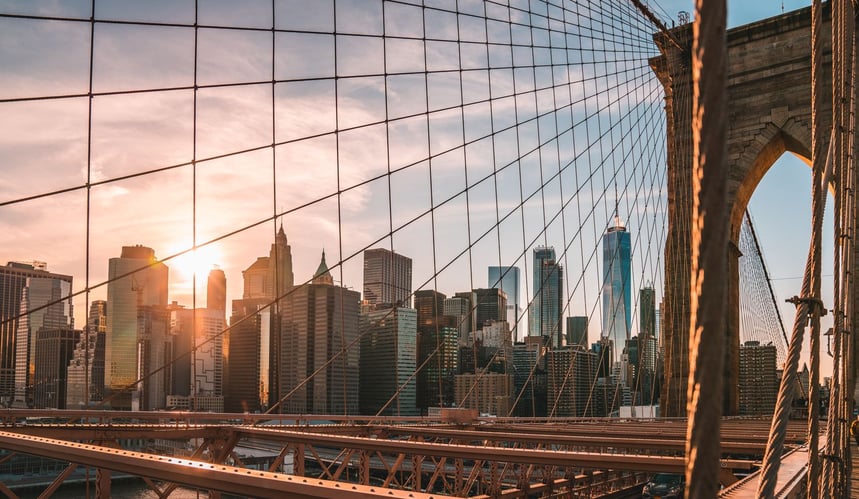 New york city bridge view with sun is on the sky behind the city view